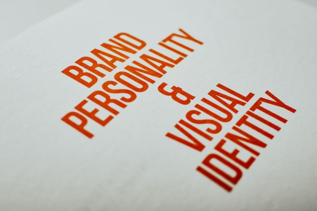 The Art of Drawing Readers In: Your attractive post title goes here Close-up of 'Brand Personality & Visual Identity' text in red on white paper.